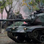Members of Taiwan's armed forces, riding on a M60A3 tank