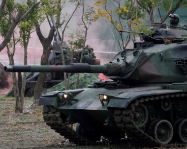 Members of Taiwan's armed forces, riding on a M60A3 tank