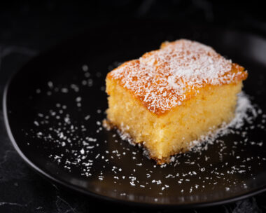 Revani dessert, Turkish traditional pastry dessert on a black plate