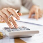 Business woman using calculator to manage finance