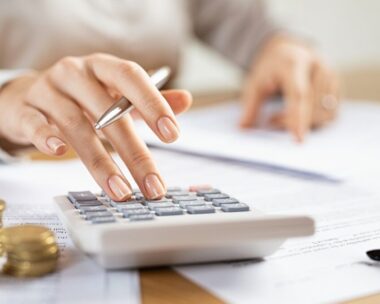 Business woman using calculator to manage finance