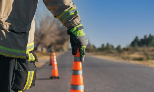 Firefighter putting cone on road