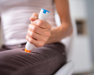 Auto Epinephrine Injector. Patient Doing Leg Injection
