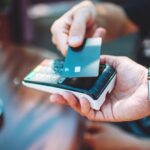Adult man paying with credit card