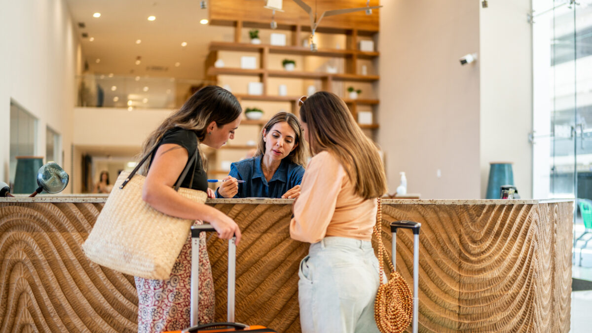 Receptionist talking with customers at a hotel lobby