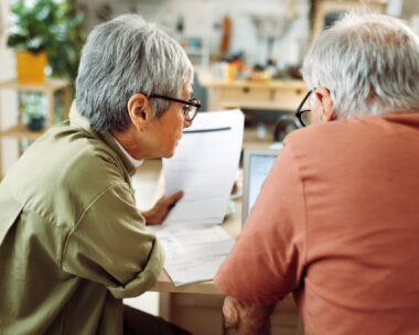 Senior couple going over bills at home