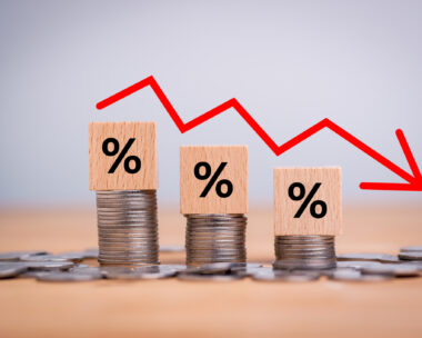 Percentage sign on wooden cubes with Stack of coin bar chart