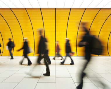 People walking in yellow tunnel