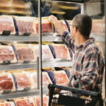 Man buying meat at grocery store