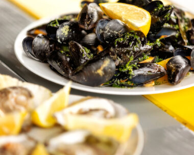 Steamed mussels in white wine sauce and oysters on the plate