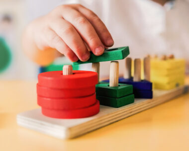 Kid playing with wood toys