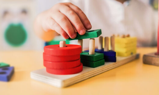 Kid playing with wood toys