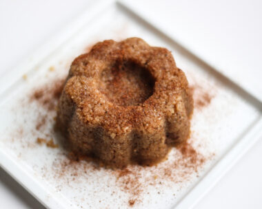 Sweet food, semolina halva on a white plate with white background.