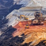 open coal mining pit with heavy machinery