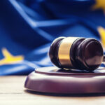 Judges wooden gavel with EU flag in the background