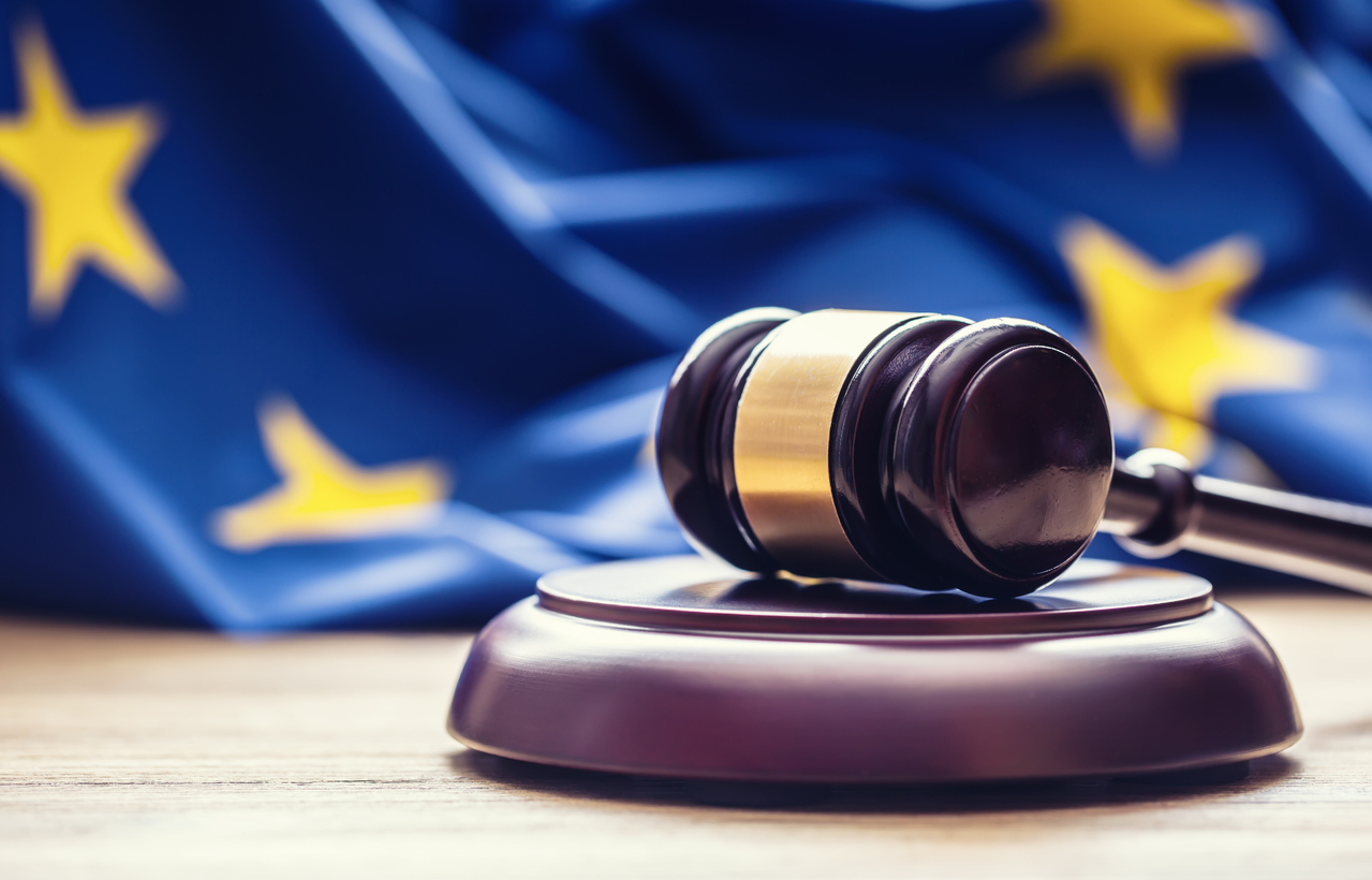 Judges wooden gavel with EU flag in the background