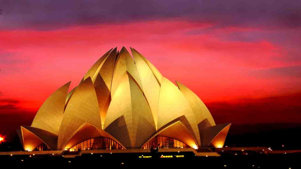 Night view of Lotus Temple with dramatic clouds in the dusk in New Delhi, India