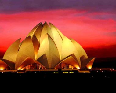 Night view of Lotus Temple with dramatic clouds in the dusk in New Delhi, India