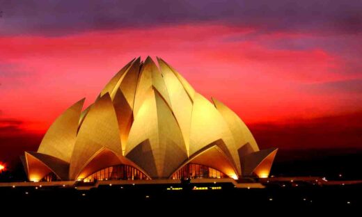 Night view of Lotus Temple with dramatic clouds in the dusk in New Delhi, India