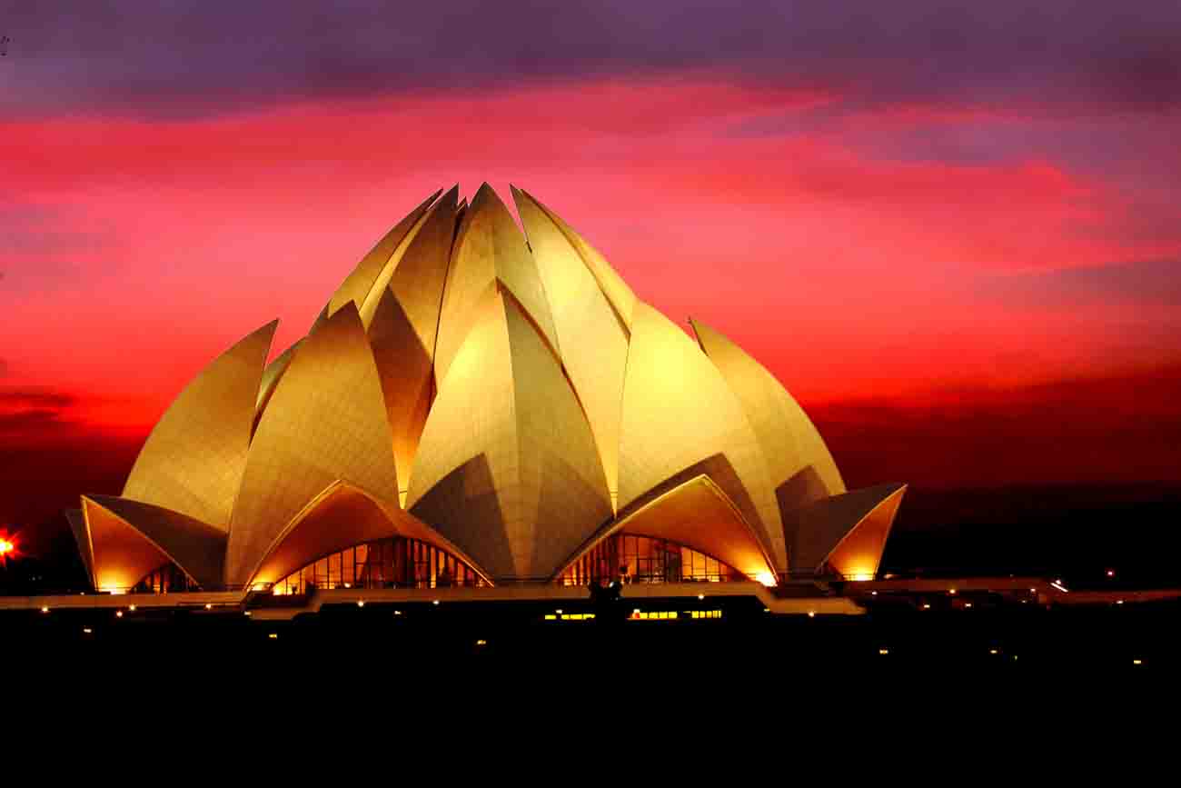 Night view of Lotus Temple with dramatic clouds in the dusk in New Delhi, India
