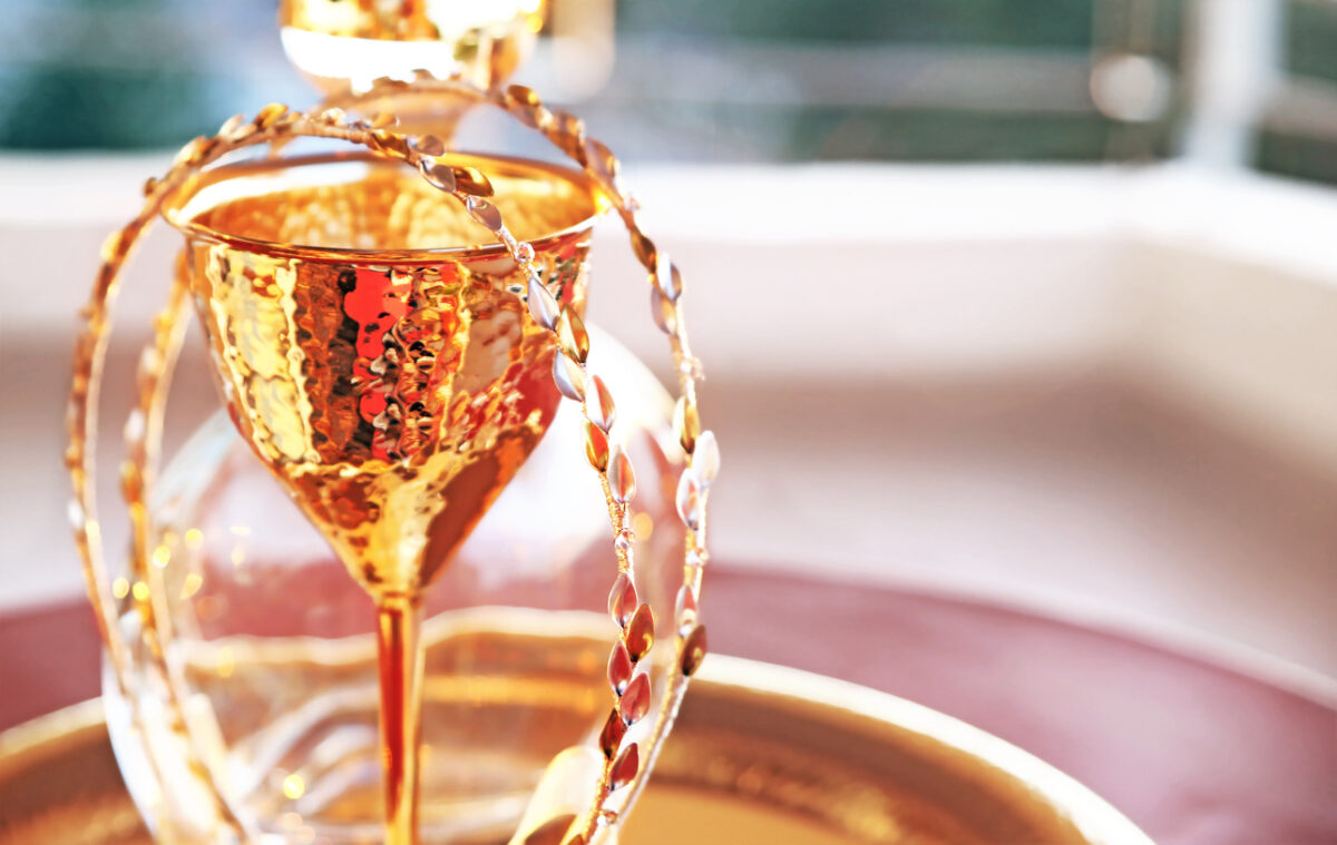 still life photography of traditional wedding crowns, decanter and chalice - greek wedding objects