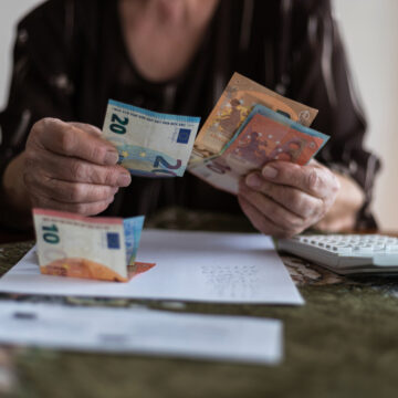 Senior man's hands holding Euro banknote