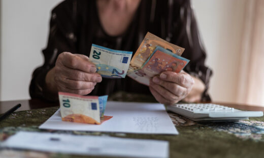 Senior man's hands holding Euro banknote
