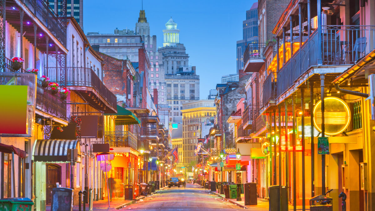 Bourbon St, New Orleans, Louisiana, USA cityscape of bars and retaurants at twilight.