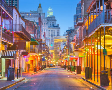 Bourbon St, New Orleans, Louisiana, USA cityscape of bars and retaurants at twilight.