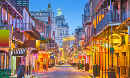 Bourbon St, New Orleans, Louisiana, USA cityscape of bars and retaurants at twilight.