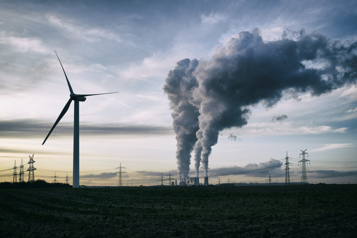 a coal burning power plant with pollution and electricity pylons