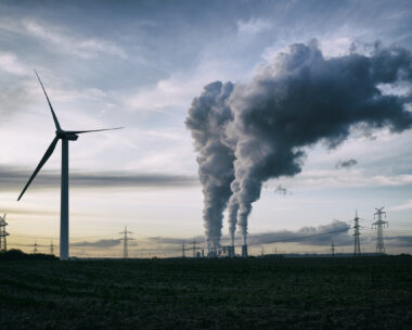 a coal burning power plant with pollution and electricity pylons