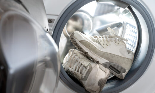 footwear hygiene - pair of dirty white sneakers in the washing machine