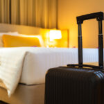 Suitcase delivered standing in hotel room
