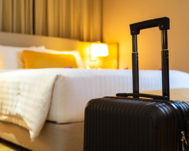 Suitcase delivered standing in hotel room