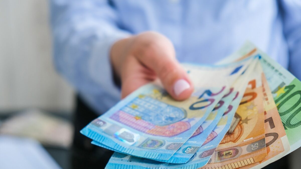 Hand giving money
