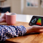 A woman holding smart energy meter