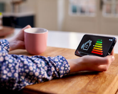 A woman holding smart energy meter