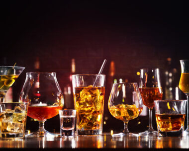 Assortment of hard strong alcoholic drinks and spirits in glasses on bar counter