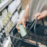 A female costumer holding a basket while shopping