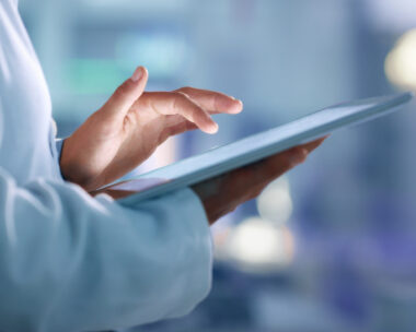 Doctor, researcher or scientist browsing the internet on a tablet for information while working at a lab, science facility or hospital. Expert, medical professional or surgeon searching the internet