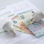 euro banknotes, a lamp and an electricity bill