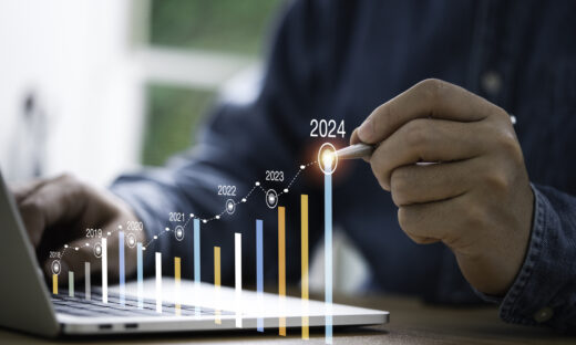 Businessman use electronic pen writing rising colorful graph from 2023 to 2024 year of business planing and stock investment growth concept
