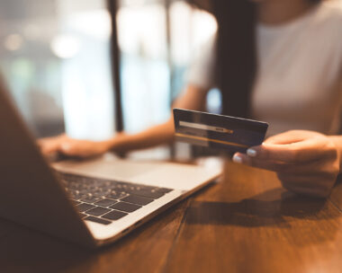 Woman hand consumer using creadit card and laptop