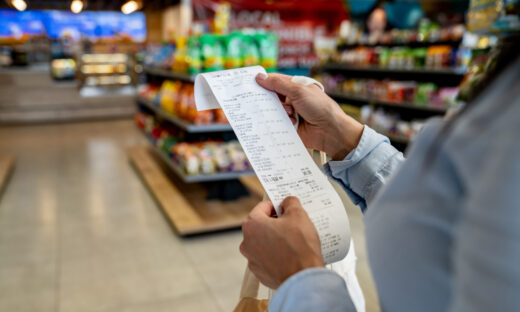 Woman shopping at a store and checking her receipt