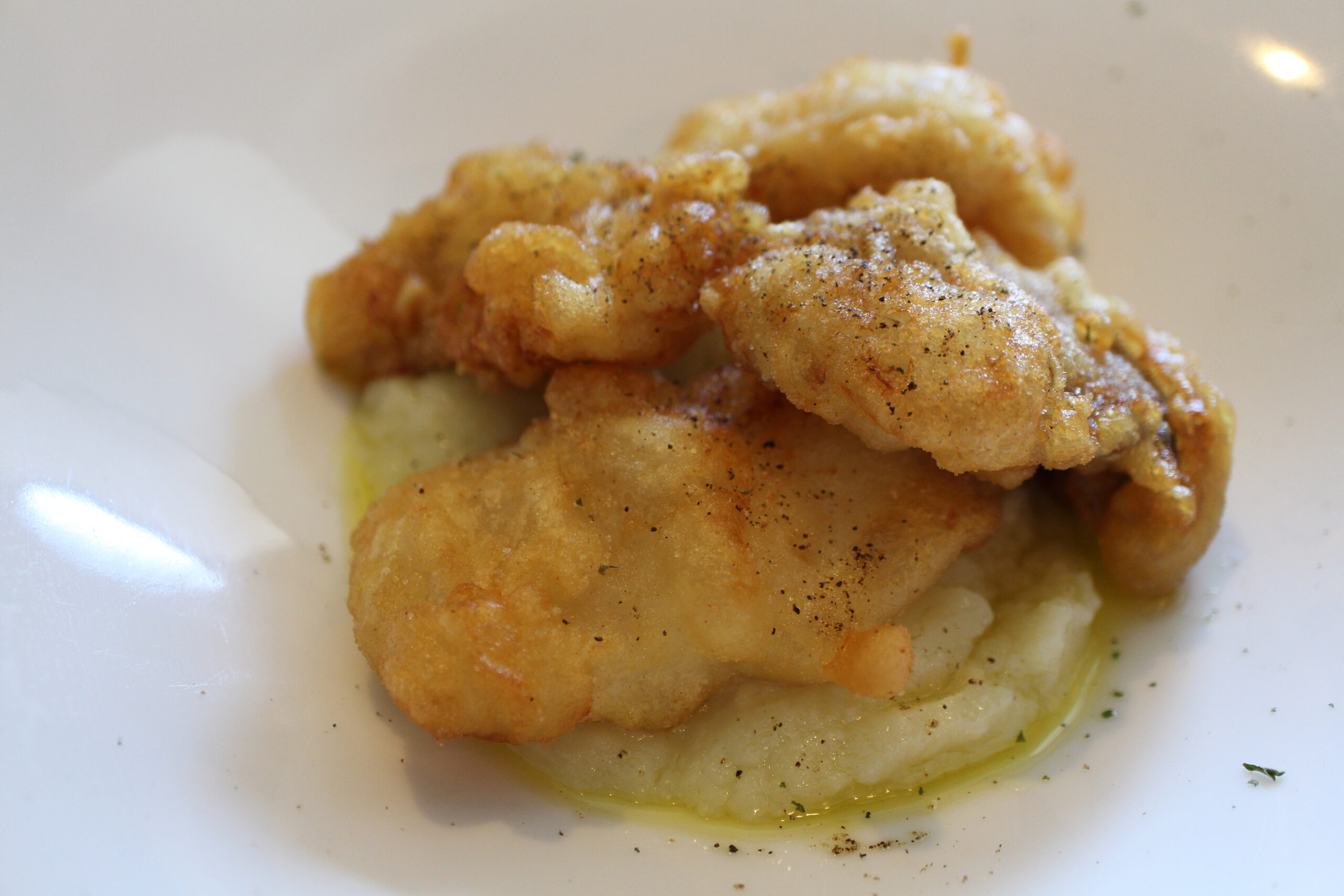 Greek cuisine: bakaliaros (fried cod) with mashed potatoes
