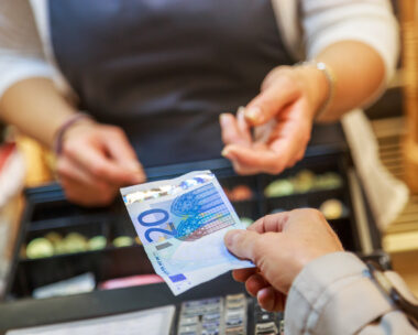 woman is paying In cash with euro