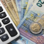 Close up of a calculator and euro money