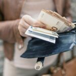Woman holding wallet with euro money