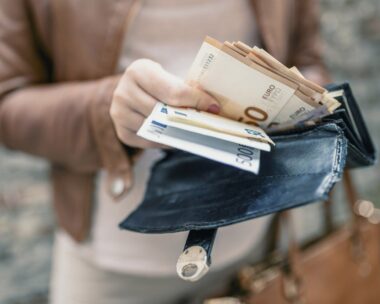 Woman holding wallet with euro money